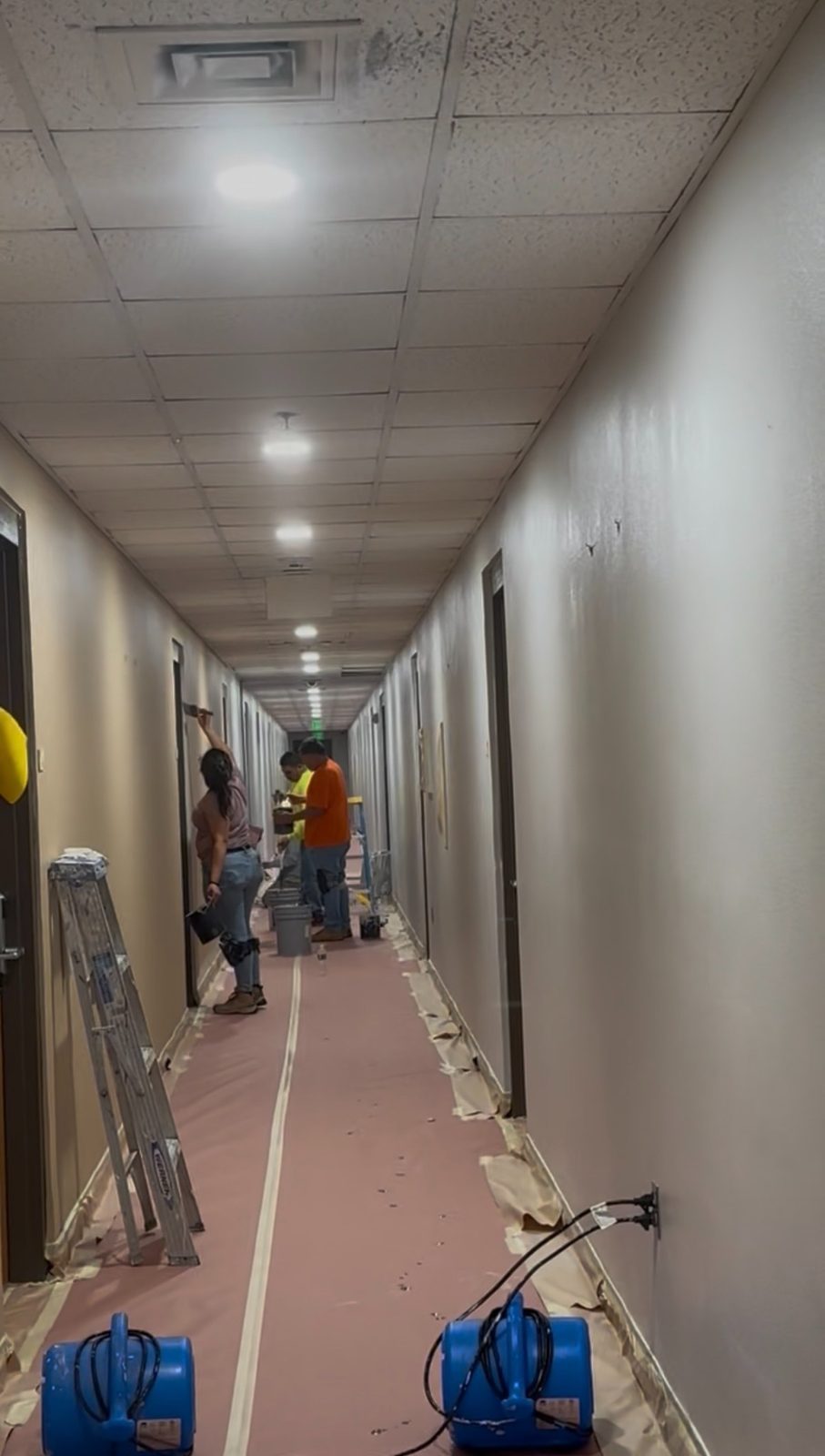 GMP Painting Solutions team preparing a commercial hallway
